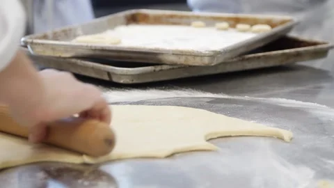 Extending donut dough in the kitchen Stock Footage 307339962