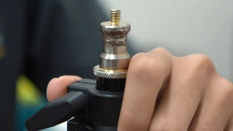 Extending the pole of a light stand Stock Footage 107325677