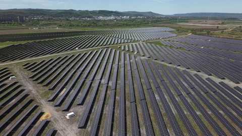 An extensive array of solar panels covers a vast field, illustrating the scale Stock-Footage 334269718