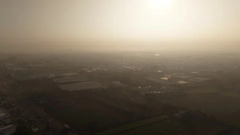 Extensive Industrial Zone with Solar Integrated Rooftops Emerging Through the Stock Footage 334289777