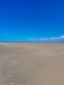 Extensive Sand Flat Ripples under Clear Blue Sky Stock Photos