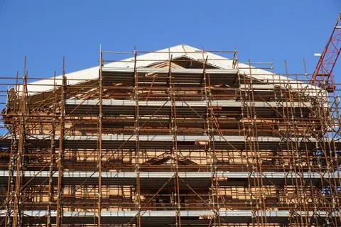 Extensive scaffolding providing platforms for work in progress on a church in Stock Photos