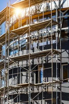 Extensive scaffolding providing platforms for work in progress on a new apart Stock Photos