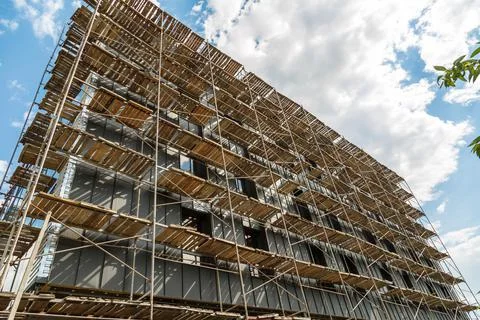 Extensive scaffolding providing platforms for work in progress on a new apart Stock Photos