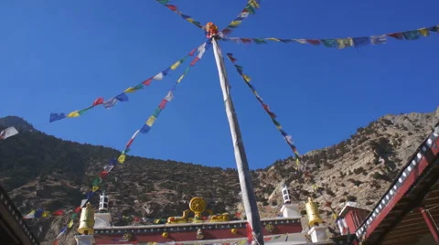 Exterior of the buddhist temple with flags fluttering in the wind, Marpha,Nepal Stock Footage 56892256