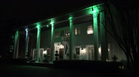 The exterior of an elegant southern colonial mansion at night. Stock Footage