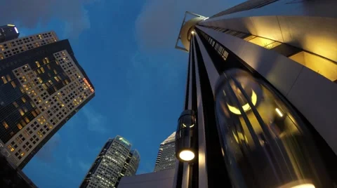Exterior Elevator of Skyscraper at Marina Bay at Dusk, Timelapse Action Stock Footage 50866327