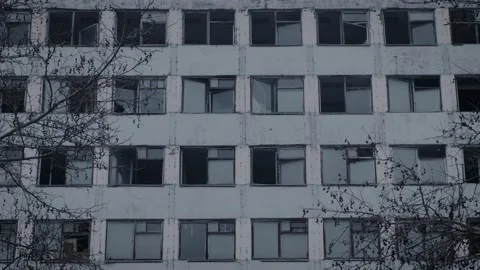Exterior of an empty multi-storey building. Broken frames and window panes Video stock 148490589