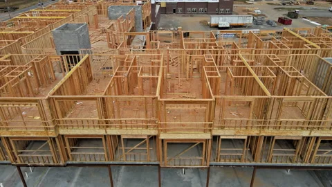 Exterior framing of wooden new homes under construction beam Stock Footage