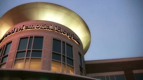Exterior of hospital building at sunrise Stock Footage