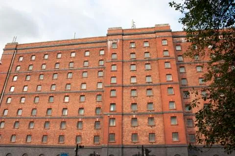 Exterior of large red brick warehouse building. Stock Photos