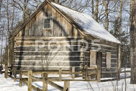 Exterior of log cab in snowy forest, Michigan Stock Photos