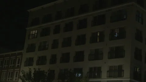 Exterior Low-Angle View of Apartment Building at Night Stock Footage 343944971