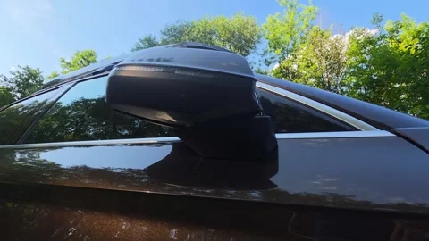 Exterior perspective of dark brown modern car side mirror, sleek design element Stockbeeldmateriaal 341657847