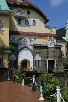 The exterior of the resort hotel features elements such as yellow walls, wh.. Stock Photos