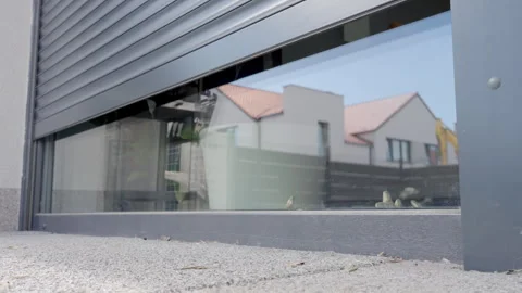 Exterior roller shutter opening on modern house window Stock Footage 334051398