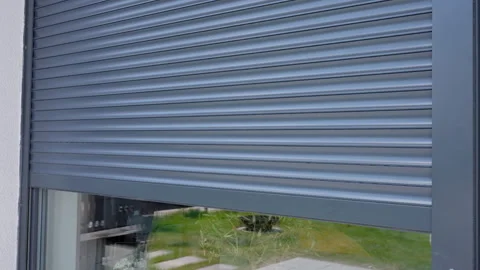Exterior roller shutter opening on modern house window Stock Footage 334673128