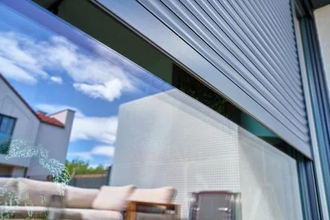 Exterior roller shutter partially open on modern house window Stock Photos