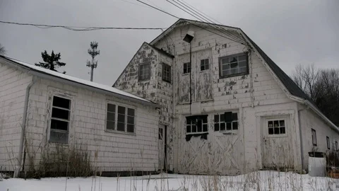 Exterior of run down white barn in mid west America in winter Stock Footage 89945501