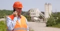 Exterior Shooting with Engineer in Front of a Cement Factory Talking to Mobile 4k or 4k+ Resolution