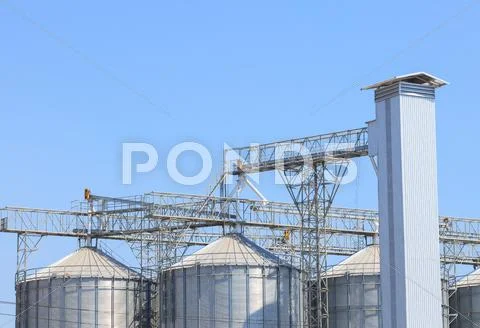 Exterior structure of new agriculture silo building against blue sky Stock Photos