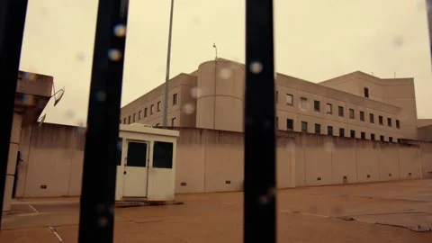 Exterior Tracking Shot Through Prison Gate Stock Footage 315530094