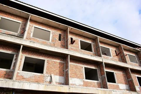 Exterior view of brick house under construction with concrete structure Stock Photos