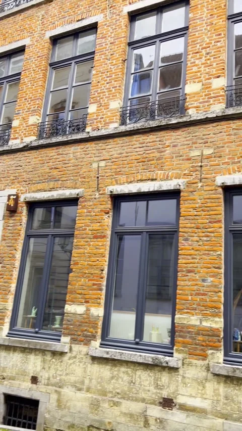 Exterior view of a charming brick building in brussels with modern touches Stock Footage 317367663