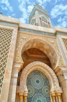 Exterior view of Hassan II Mosque showing Islamic Architecture and a blue sky Stock Photos