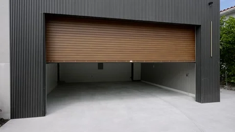 Exterior view of opening automatic garage door in modern high-tech suburban Stock Footage 259715057