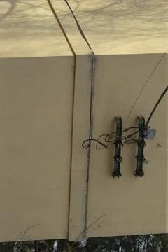Exterior wall with electrical insulators and overhead wires Stock Photos