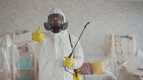 Exterminator shows his thumb up and looks into the camera Stock Footage