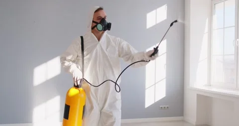 Exterminator spraying floor to kill insects, spray toxic insecticide in empty Stock Footage 341840651