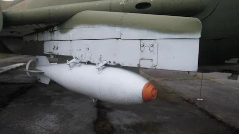 External bomb mounted under fuselage ready for transport, ground loader staging Stock Photos