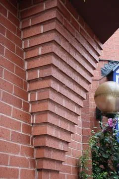 External Brick feature triangular shaped pillar Stockfoto's