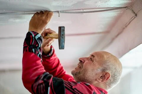 External electrical wiring in process of repairing rural house, an elderly man Stock Photos