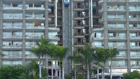 External elevator in a luxury resort and palms Stock Footage 80230587