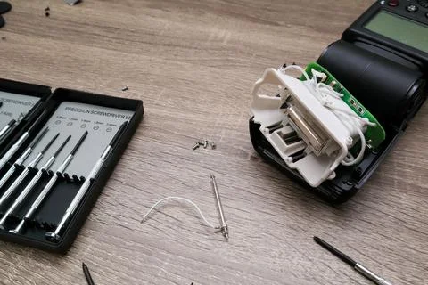 External flash repair. Replacing the halogen lamp in a photo flash. Repair .. Stock Photos