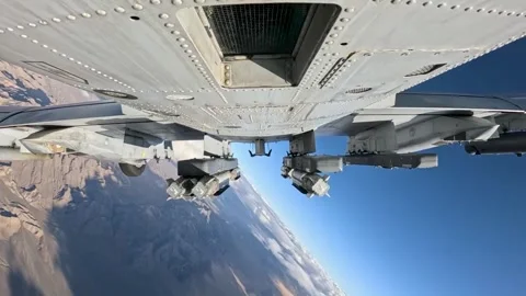 External footage of A-10 Thunderbolt deploying bombs over desert Stock Footage 280034532