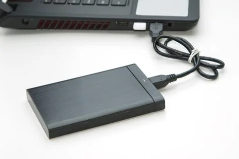External hard disk connect to computer notebook on white. Stock Photos