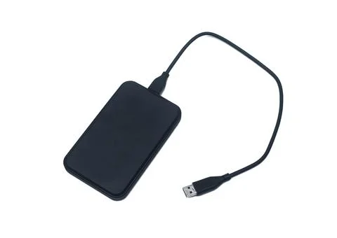 External hard disk drive with USB cable isolated on white background. Stock Photos