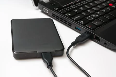 External hard disk (HDD) connected to laptop computer by USB cable Stock Photos