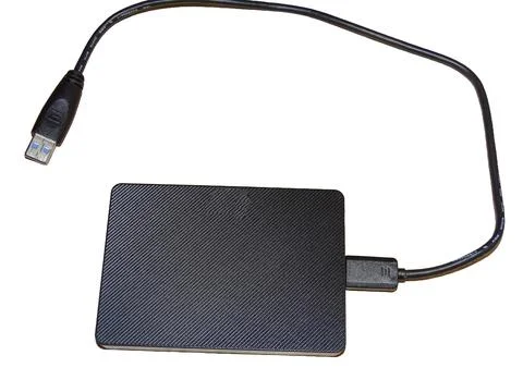 External hard drive with cable isolated on white 库存照片
