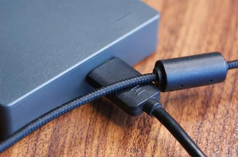 External hard drive with cables close-up. Stock Photos