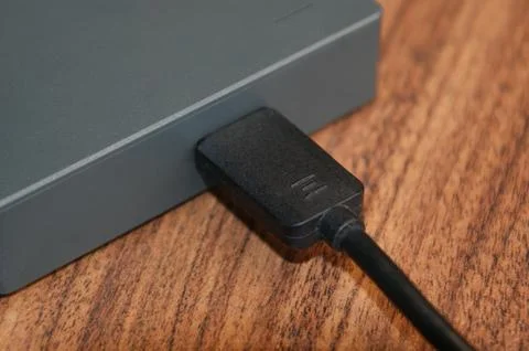 External hard drive with connected cable. Stock Photos