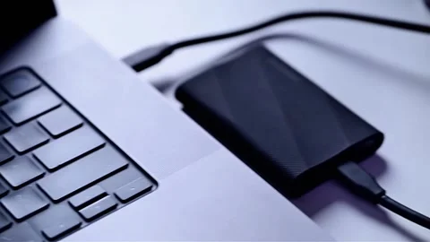 External Hard Drive Connected to Laptop for Data Storage and Backup Stock Footage 342583402