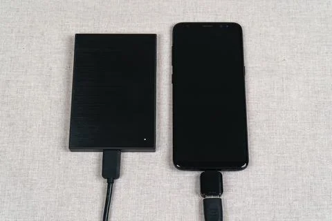 External hard drive is connected to the smartphone Stock Photos