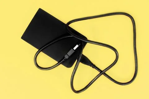 External hard drive on a yellow background Stock Photos