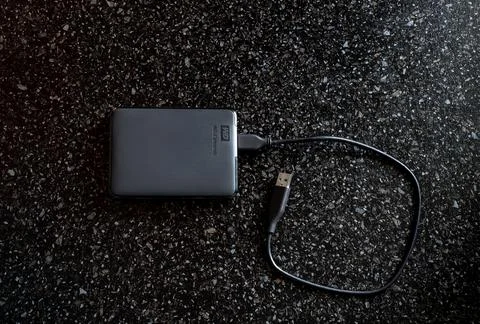 External HDD WD Elements Portable in a black case with a wire on a black back Stock Photos