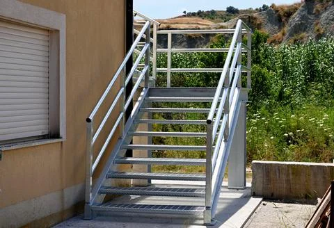 An external metal fire escape made of galvanized steel. Stock Photos